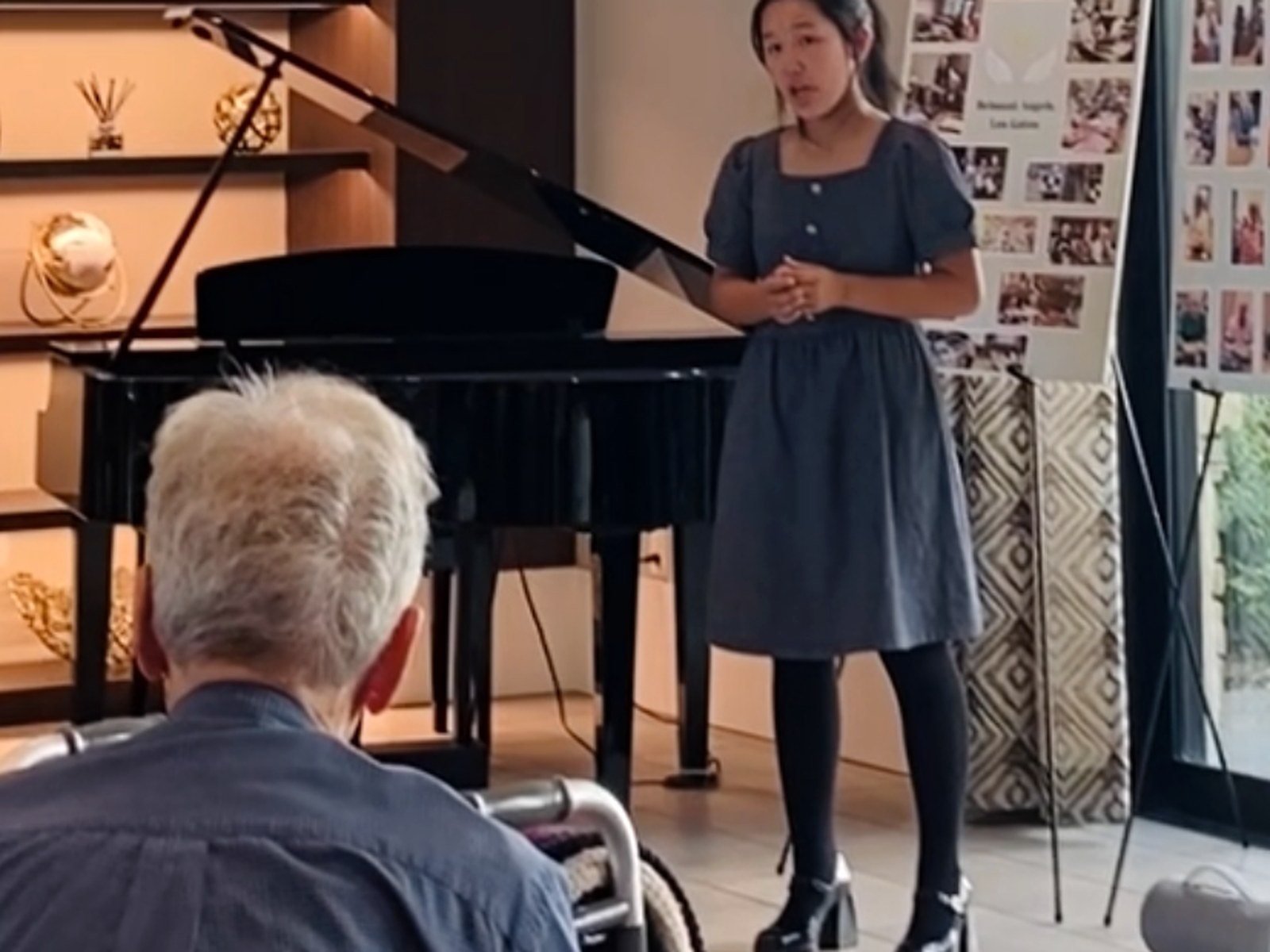 A young vocalist performing for senior residents.