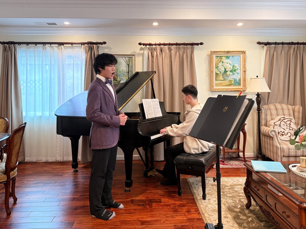 A student vocalist rehearsing with piano accompaniment.