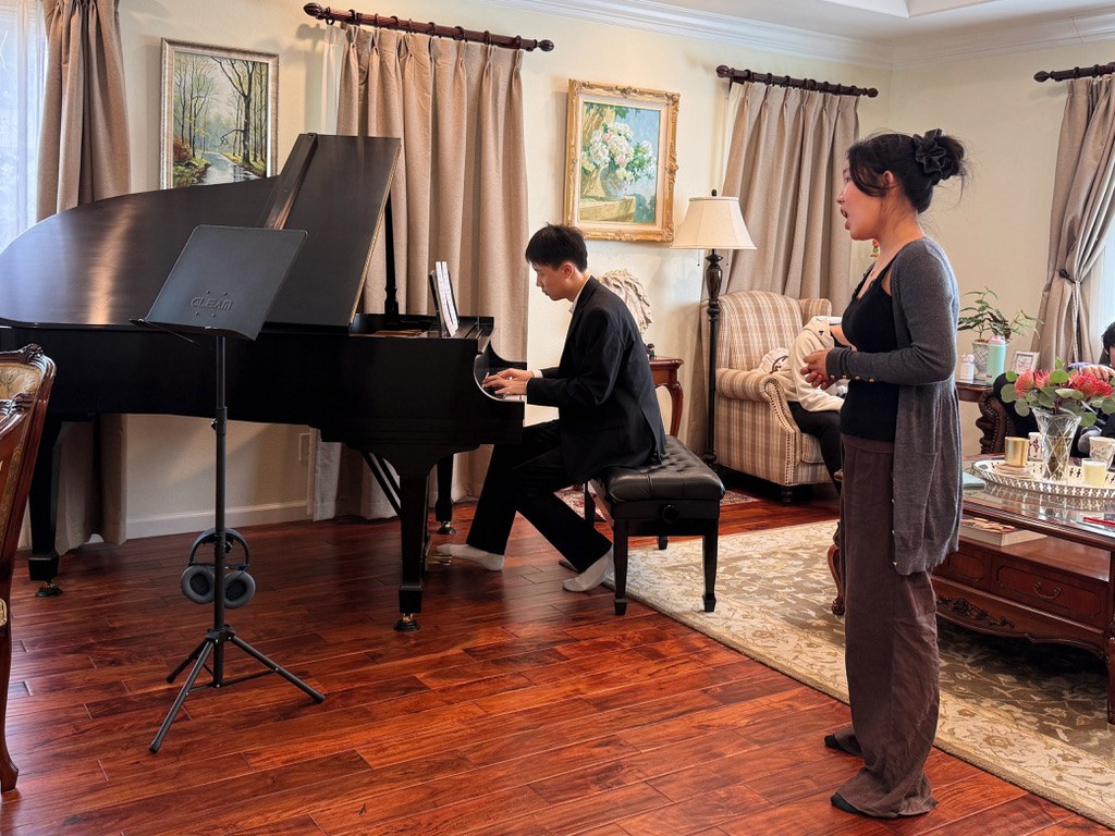 A student vocalist rehearsing with a pianist.