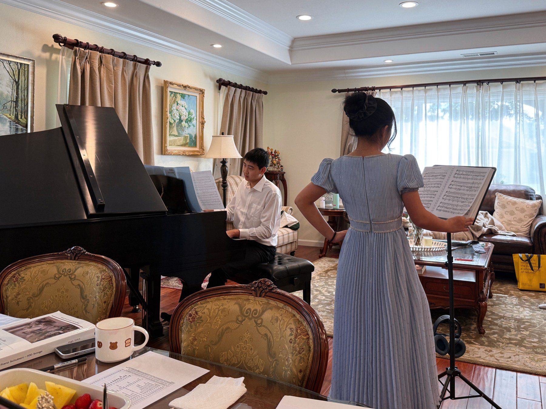 A vocalist and pianist practicing together during an ensemble rehearsal.