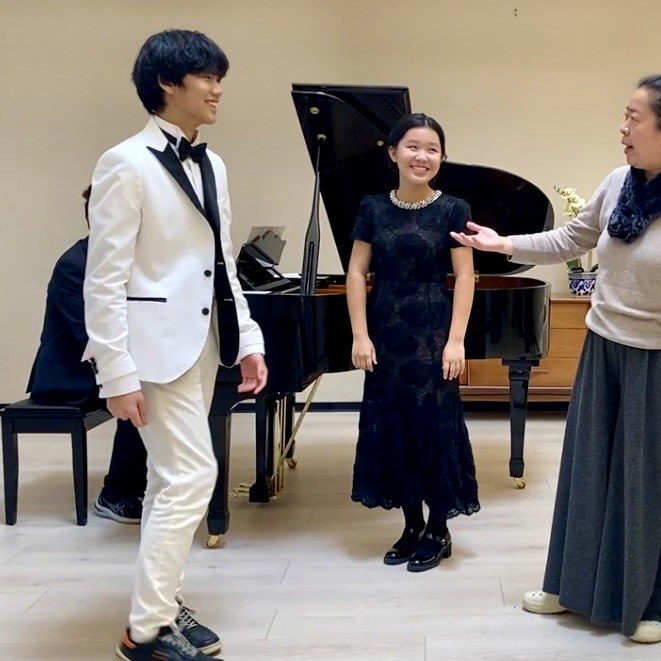 Young performers receiving coaching during rehearsal.